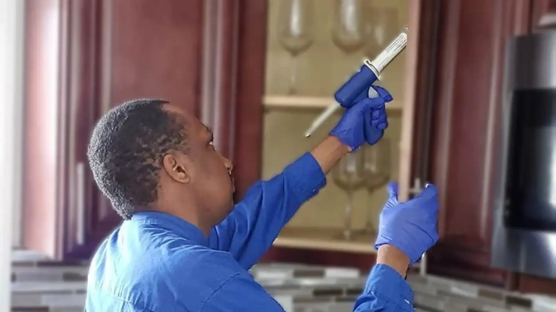 EM Pest Control technician treating for roaches