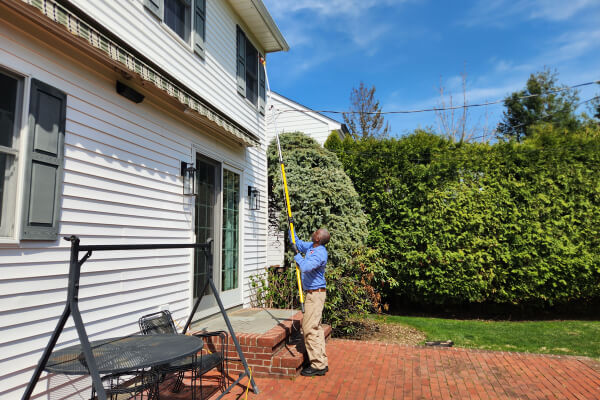 Technician treating for carpenter bees
