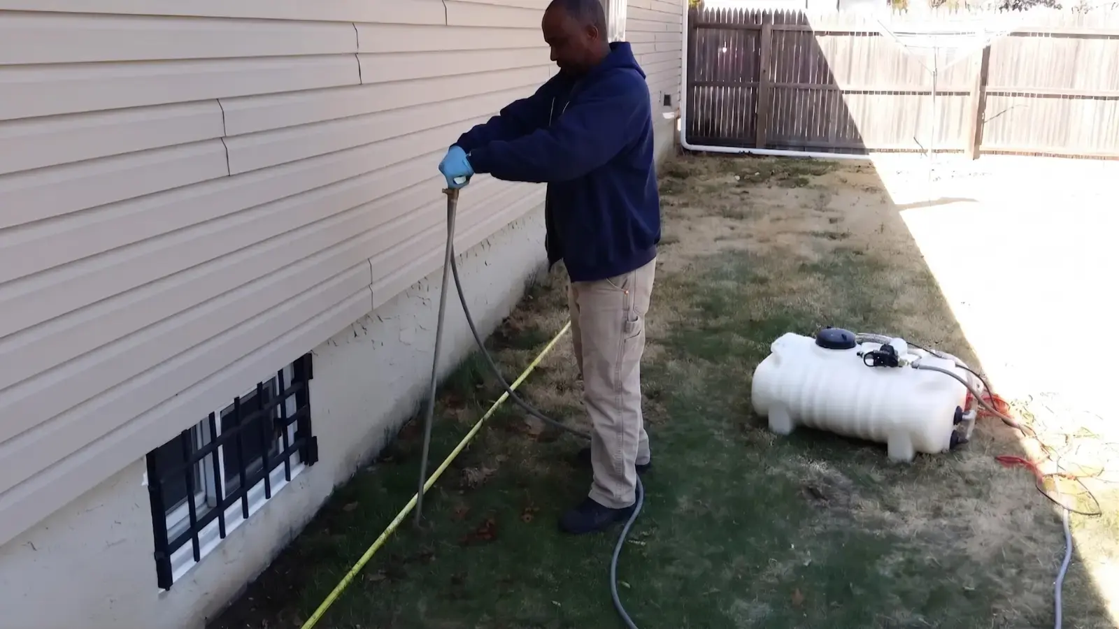 Applying a liquid termite treatment around a home's foundation